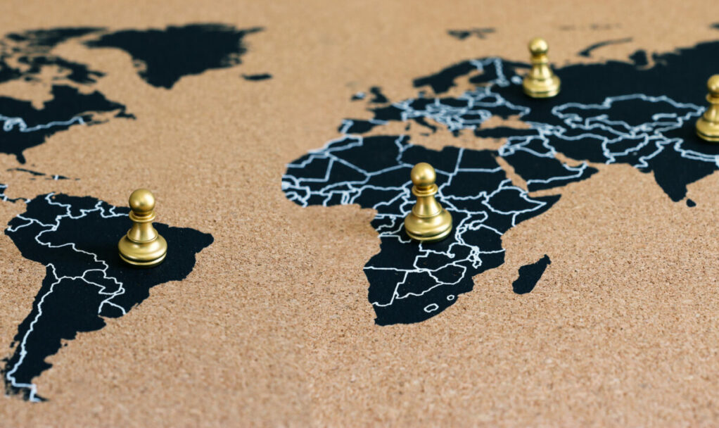 concept of geopolitics or worldwide economy. chess figures placed on map banner