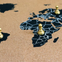 concept of geopolitics or worldwide economy. chess figures placed on map banner