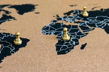 concept of geopolitics or worldwide economy. chess figures placed on map banner
